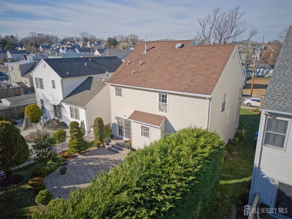 an aerial view of a house with a yard and large tree