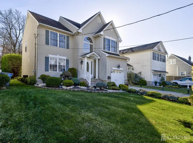 a front view of a house with a garden