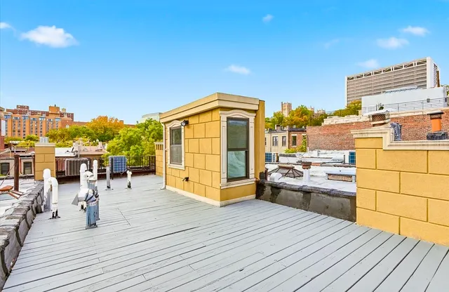 a view of balcony with wooden floor and city view
