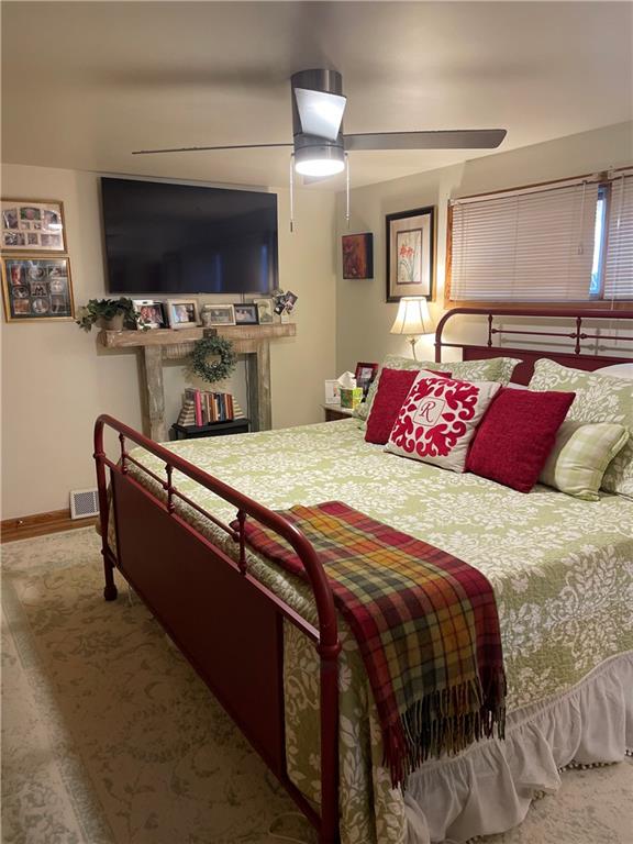 128 Lebanon Church Road Pittsburgh, PA 15236 - Photo 16 of 28 a bedroom with bed and a flat tv screen on dresser