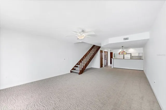 a kitchen with granite countertop a sink and white cabinets