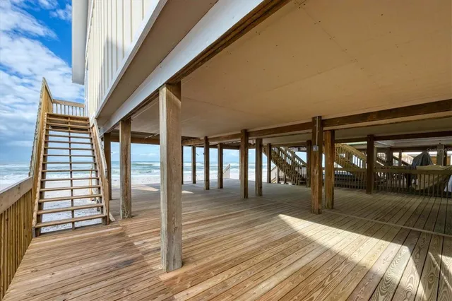 a view of a backyard with plants and a bench