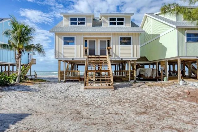 a view of a house with a yard and sitting space