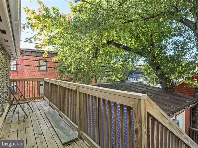 a view of a house with a yard and a wooden deck