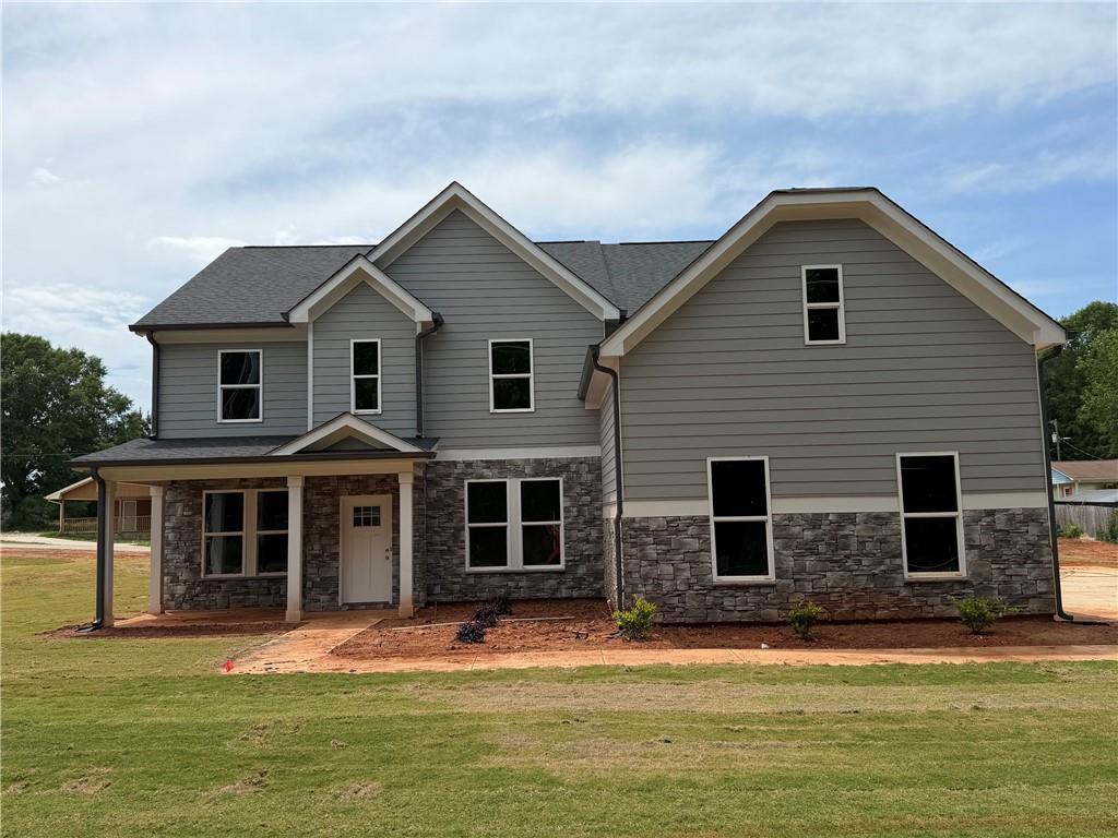 a front view of house with yard and green space