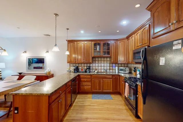 a kitchen with stainless steel appliances granite countertop sink stove and cabinets