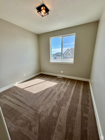 1184 West 3250 North Ogden, UT 84414 - Photo 40 of 69 Bedroom featuring neutral wall paint, a double-pane window, and patterned carpet flooring