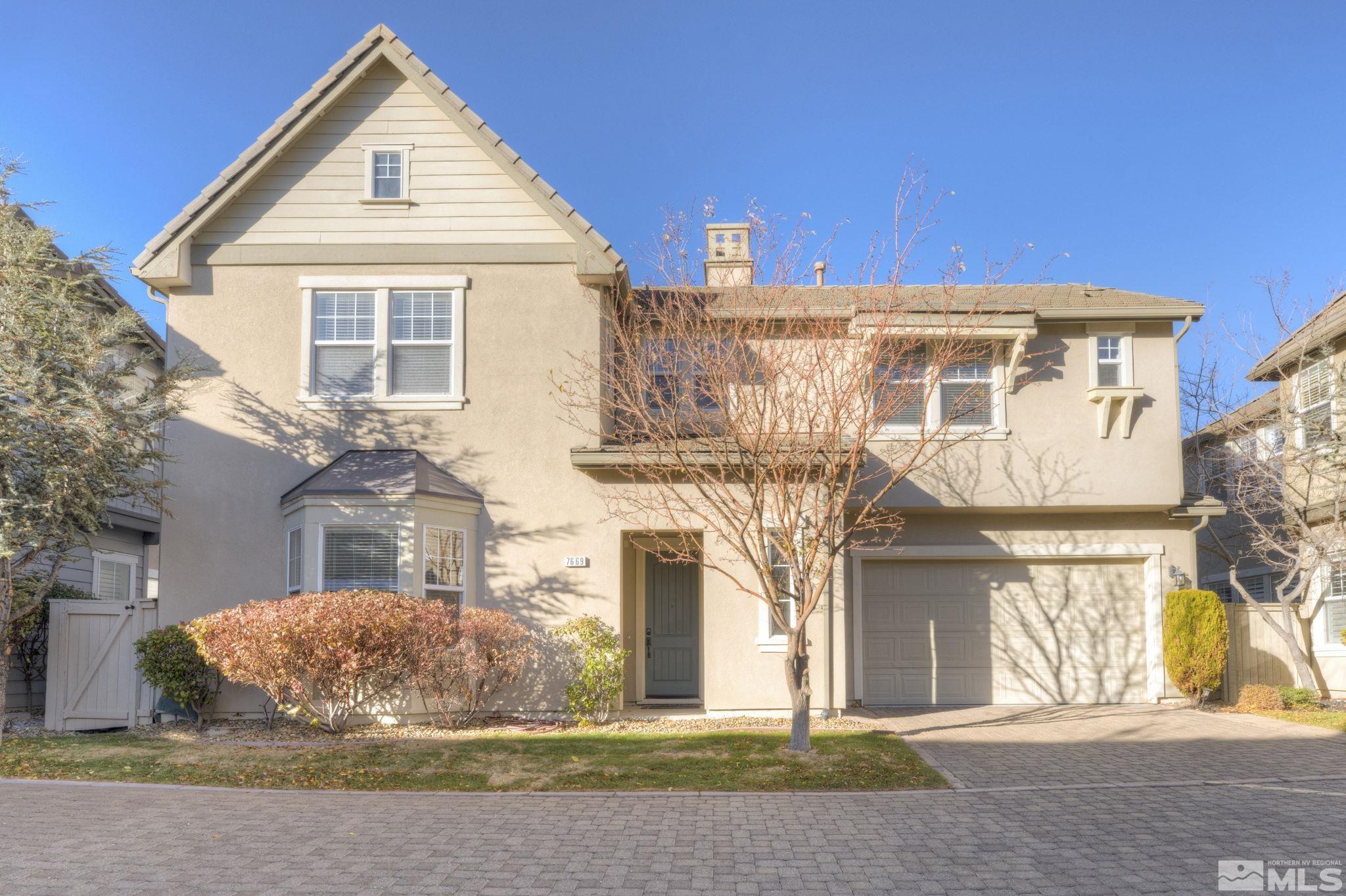 7669 Stone Bluff Way Reno, NV 89523 - Photo 1 of 40 a view of a white house with large windows