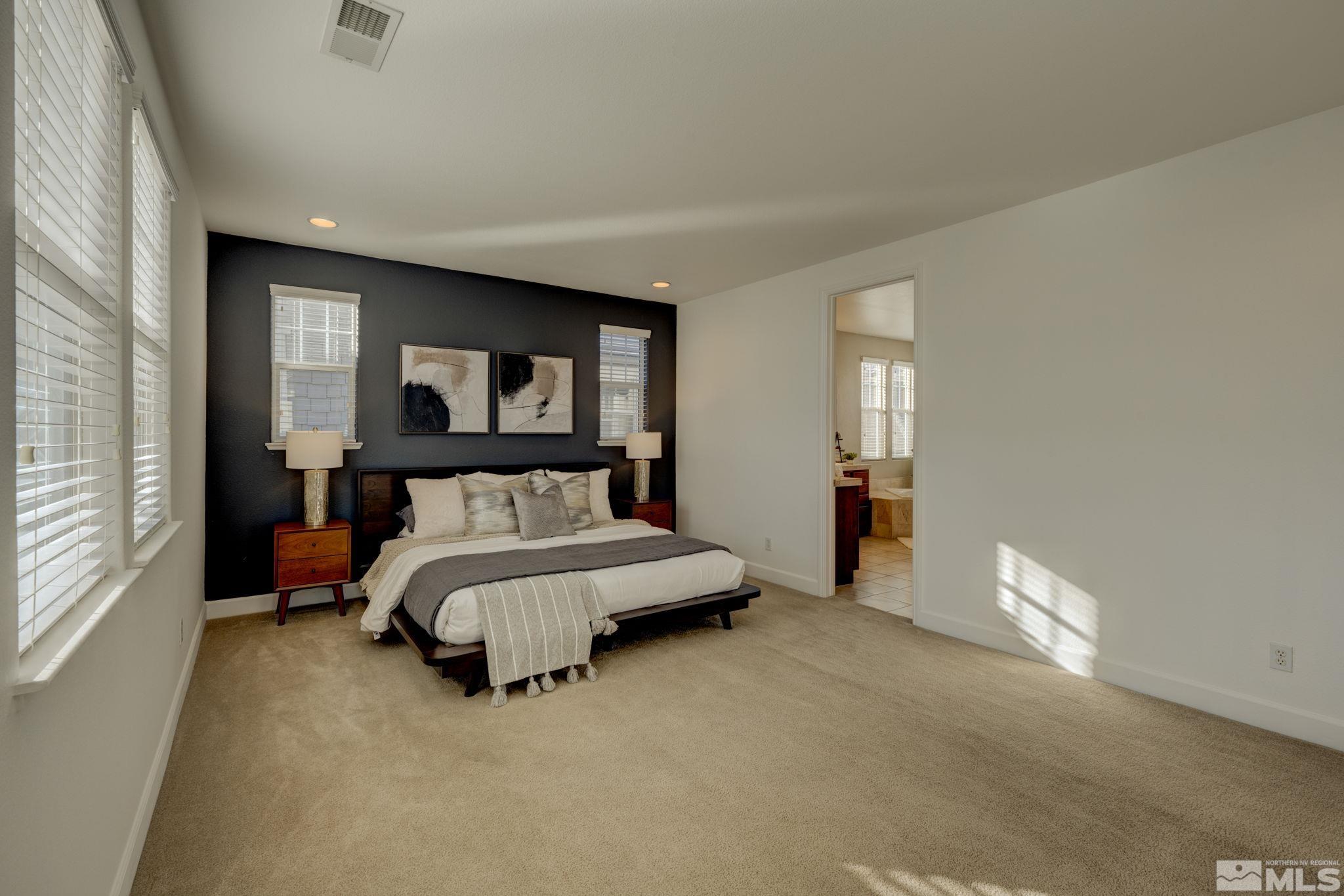 7669 Stone Bluff Way Reno, NV 89523 - Photo 21 of 40 a bed sitting in a spacious bedroom next to a window