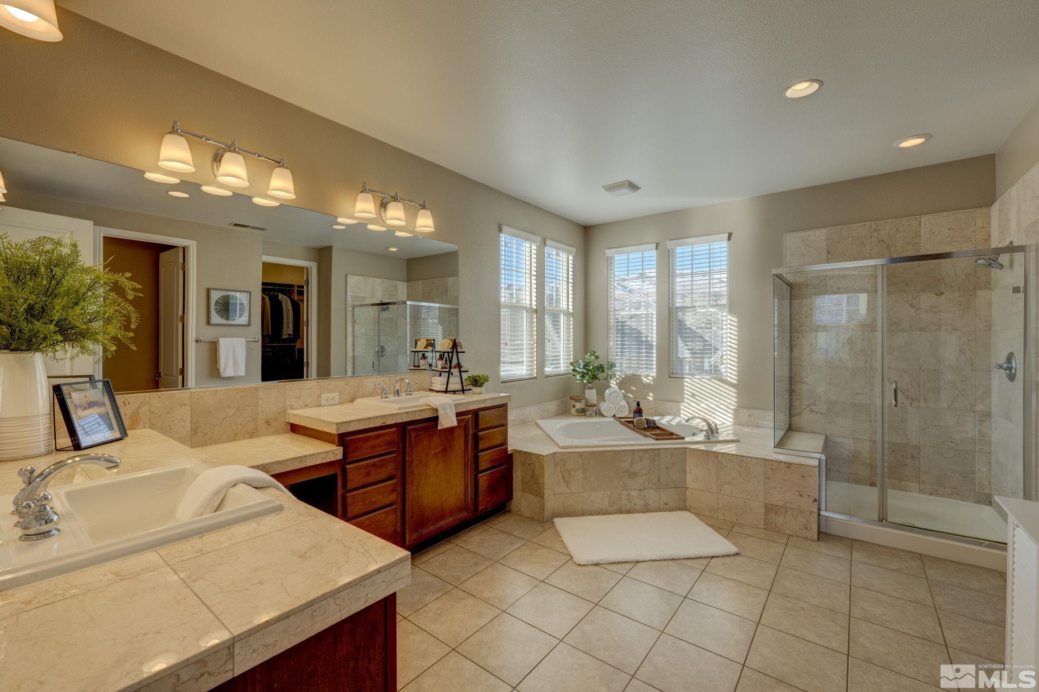 7669 Stone Bluff Way Reno, NV 89523 - Photo 23 of 40 a large bathroom with a large tub and sink