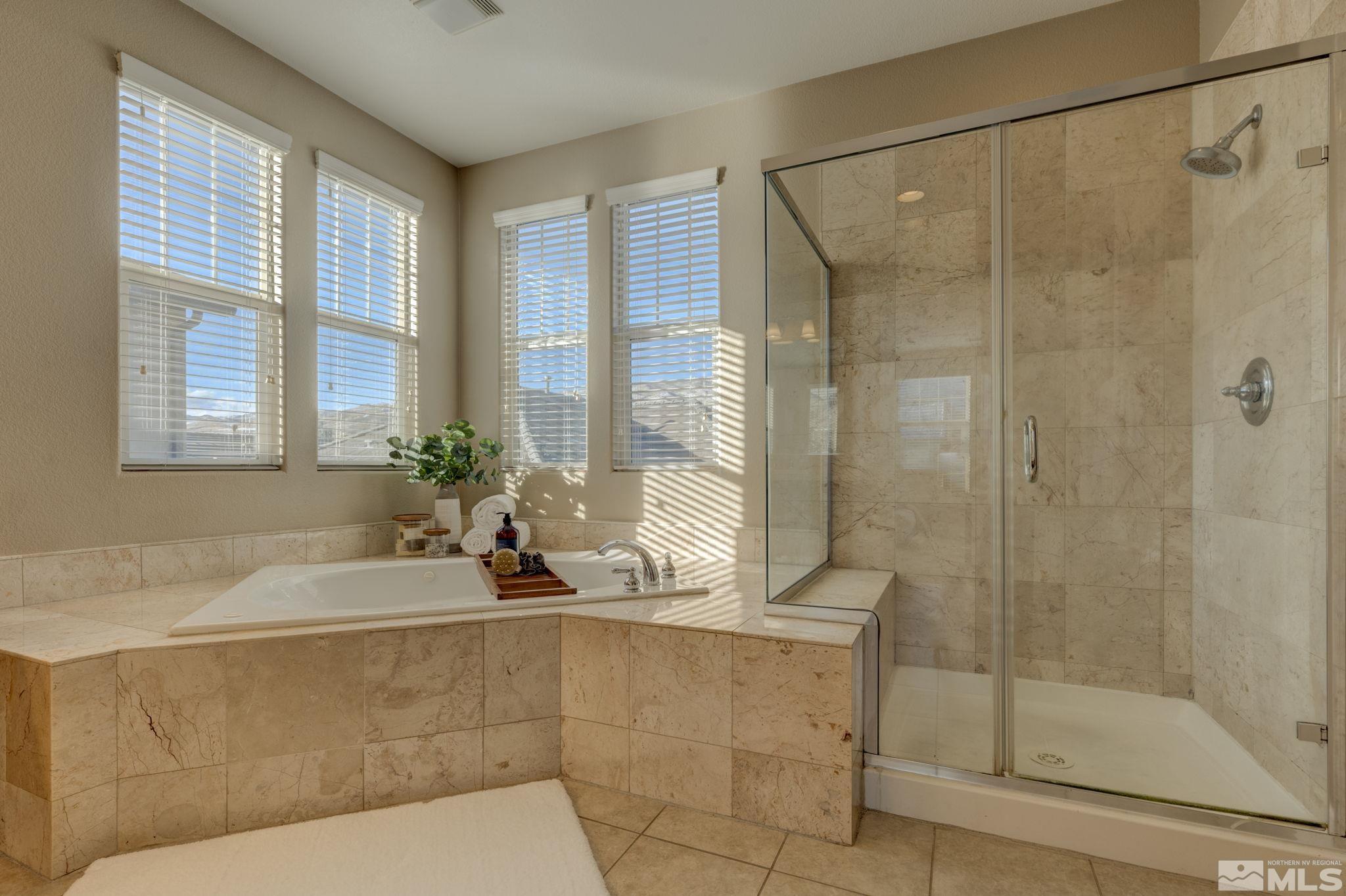 7669 Stone Bluff Way Reno, NV 89523 - Photo 25 of 40 a bathroom with a bathtub and a shower