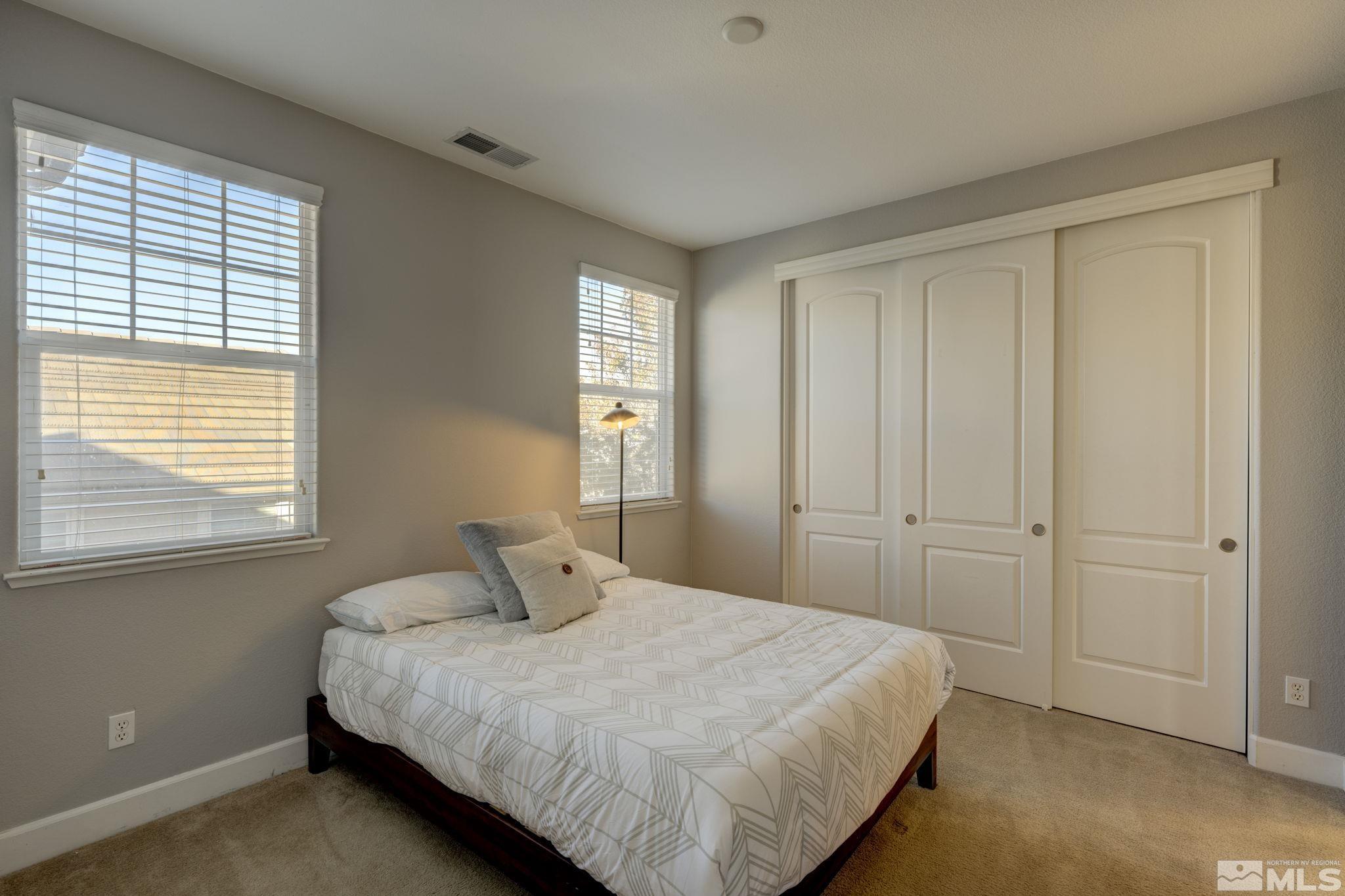 7669 Stone Bluff Way Reno, NV 89523 - Photo 27 of 40 a bedroom with a bed and window