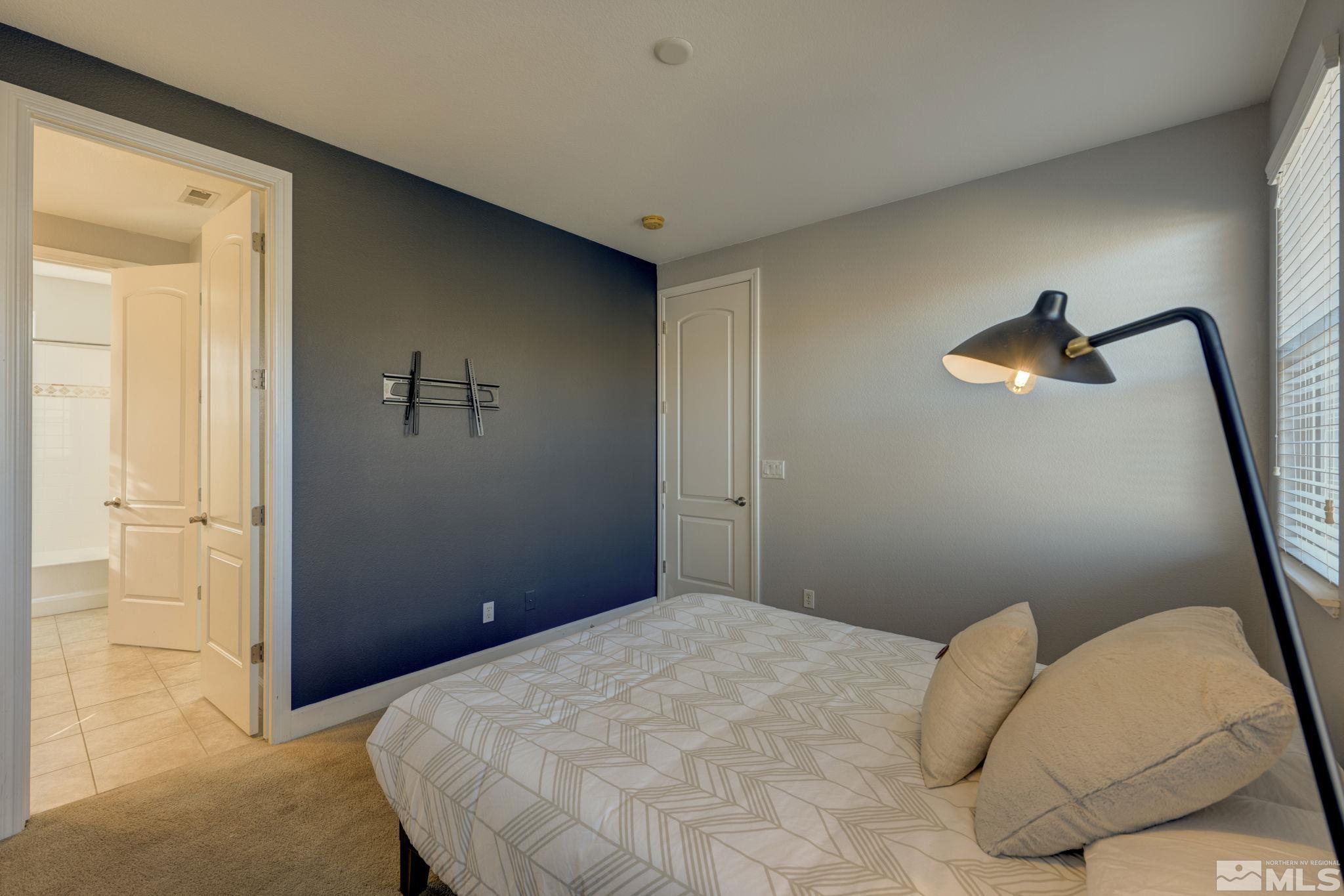7669 Stone Bluff Way Reno, NV 89523 - Photo 28 of 40 a bedroom with a bed and a lamp