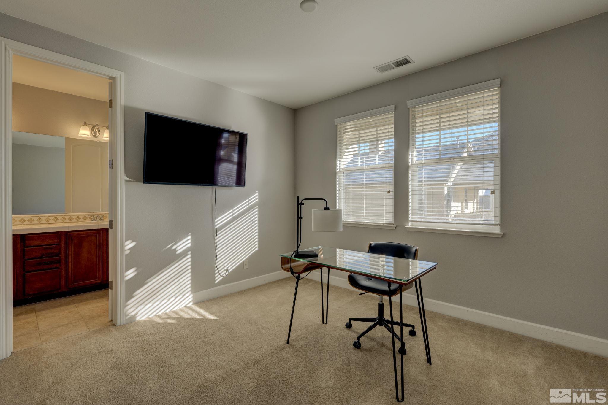 7669 Stone Bluff Way Reno, NV 89523 - Photo 32 of 40 a living room with furniture and a flat screen tv