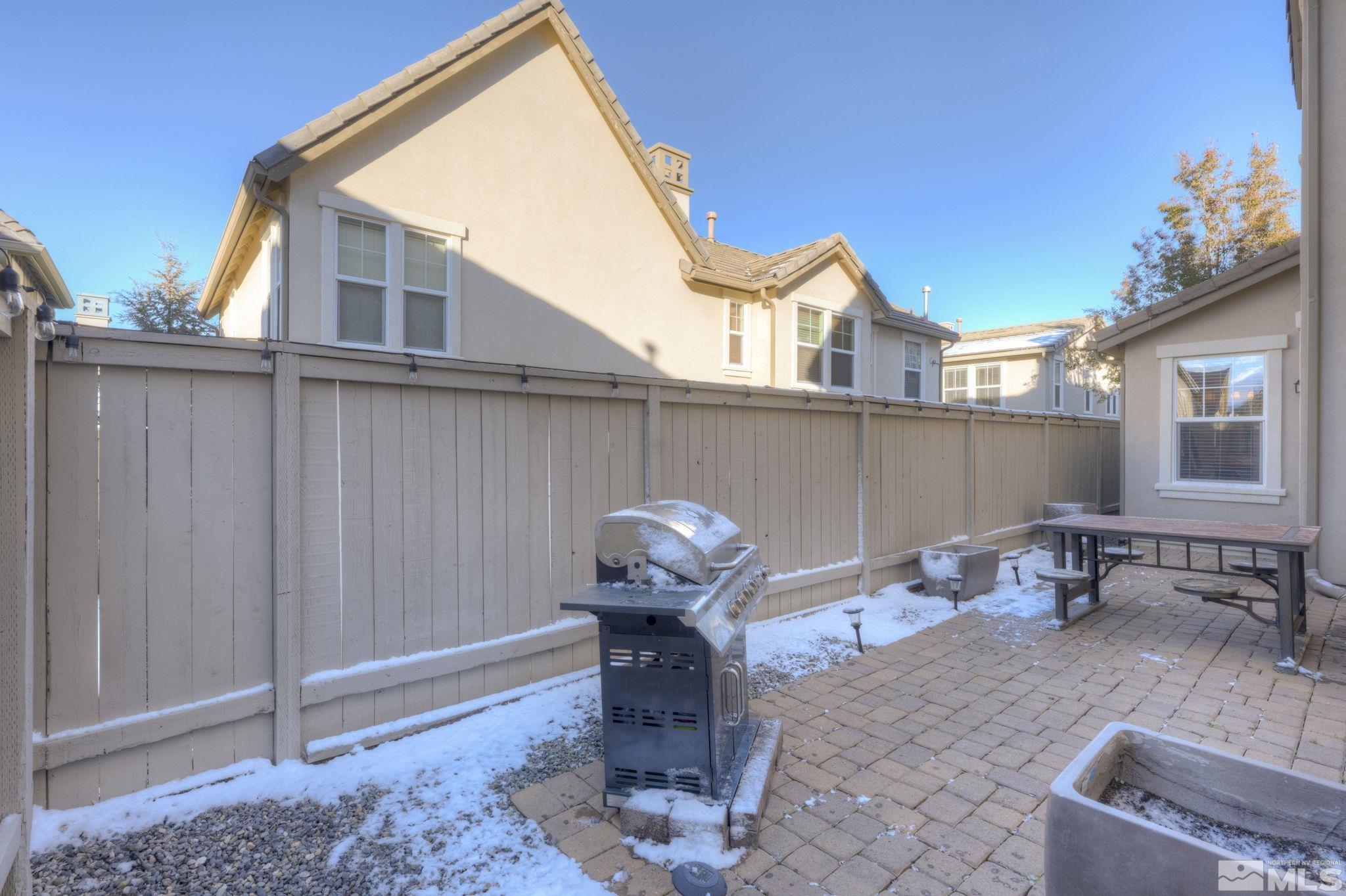 7669 Stone Bluff Way Reno, NV 89523 - Photo 33 of 40 a backyard of a house with table and chairs