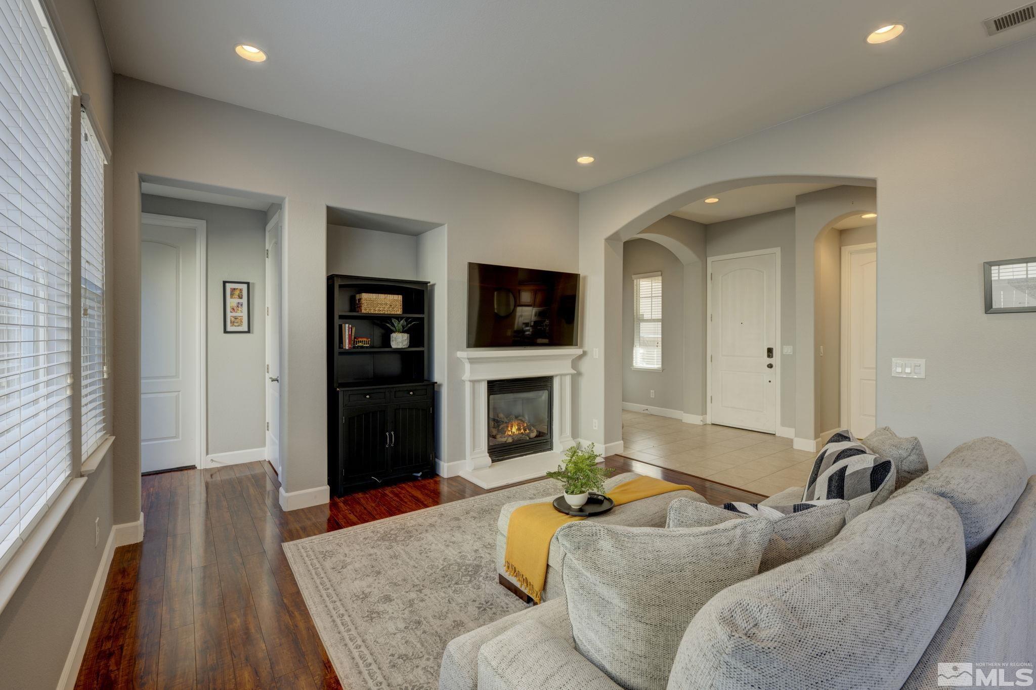 7669 Stone Bluff Way Reno, NV 89523 - Photo 4 of 40 a living room with furniture and a fireplace