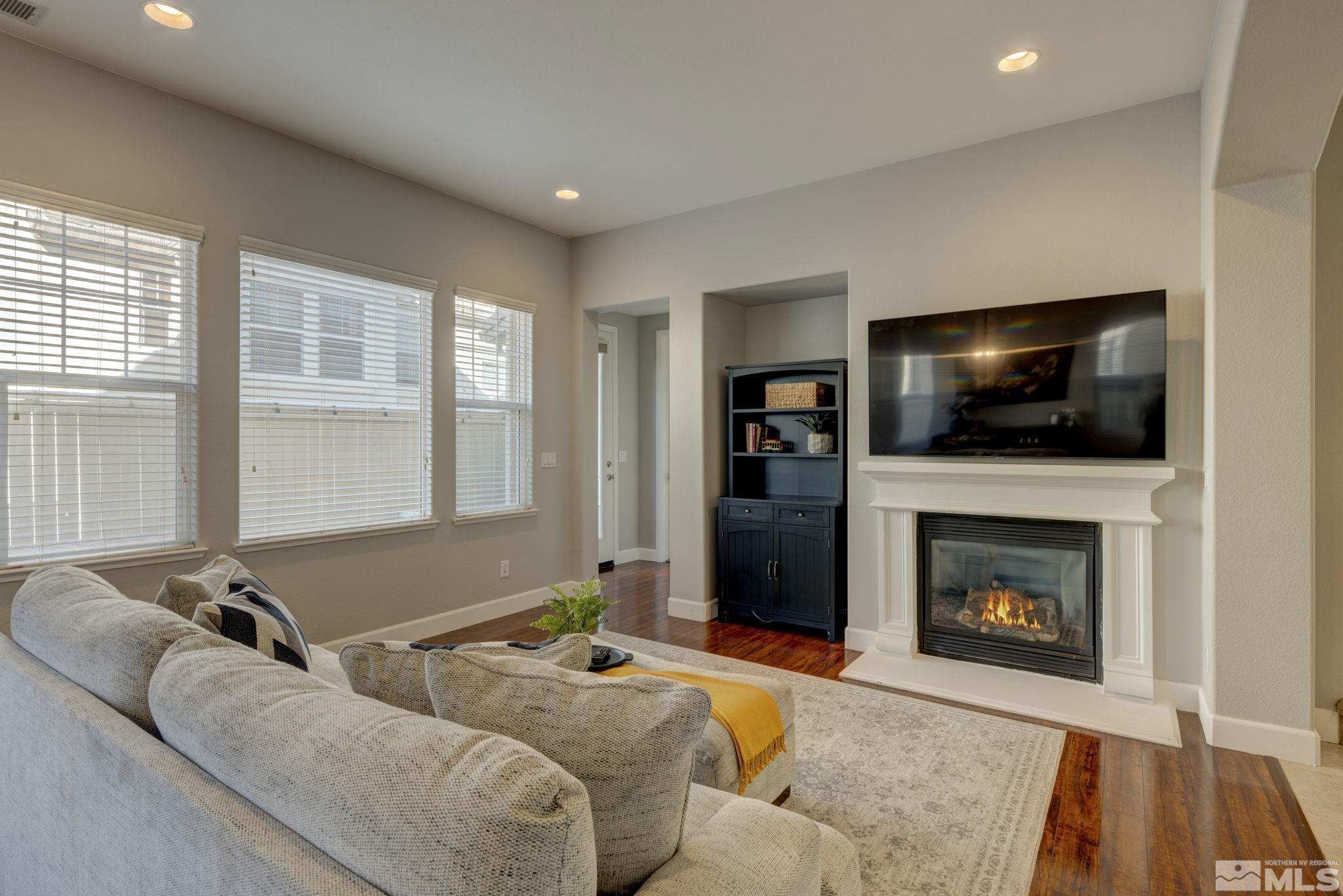 7669 Stone Bluff Way Reno, NV 89523 - Photo 5 of 40 a living room with furniture and a fireplace