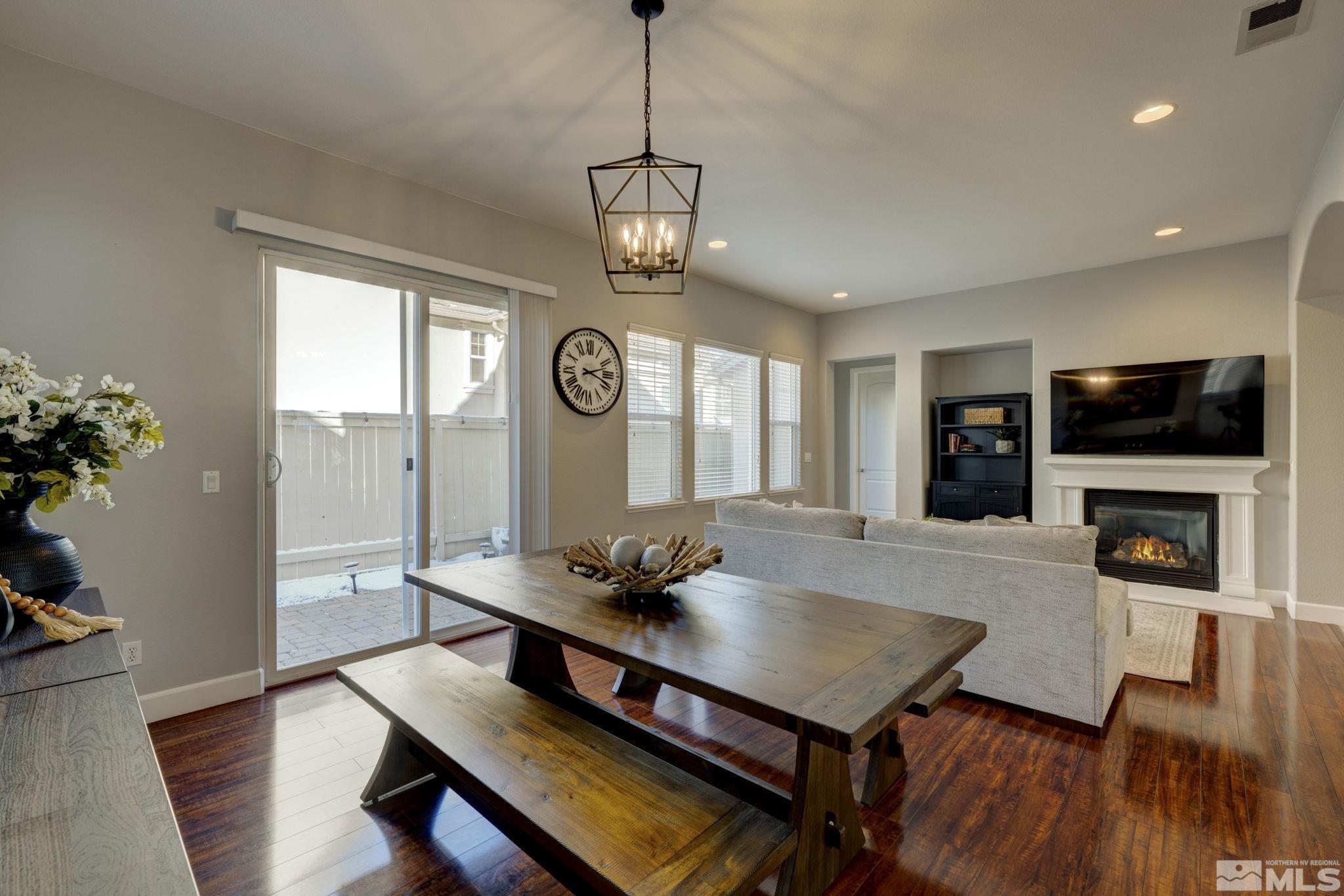 7669 Stone Bluff Way Reno, NV 89523 - Photo 6 of 40 a view of a dining room with furniture window and wooden floor