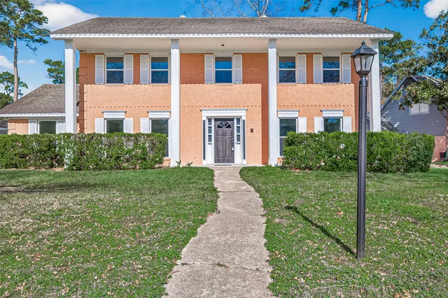 a front view of a house with garden