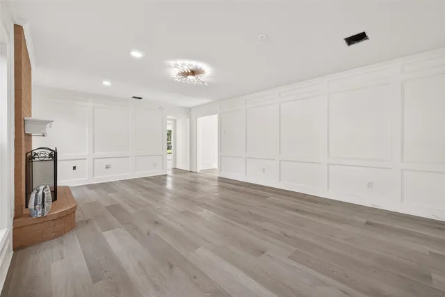 a view of a room with wooden floor and a ceiling fan