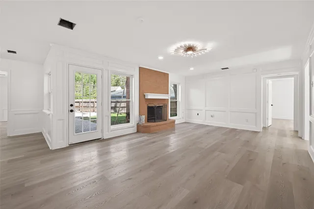 a view of a livingroom with furniture fireplace and wooden floor