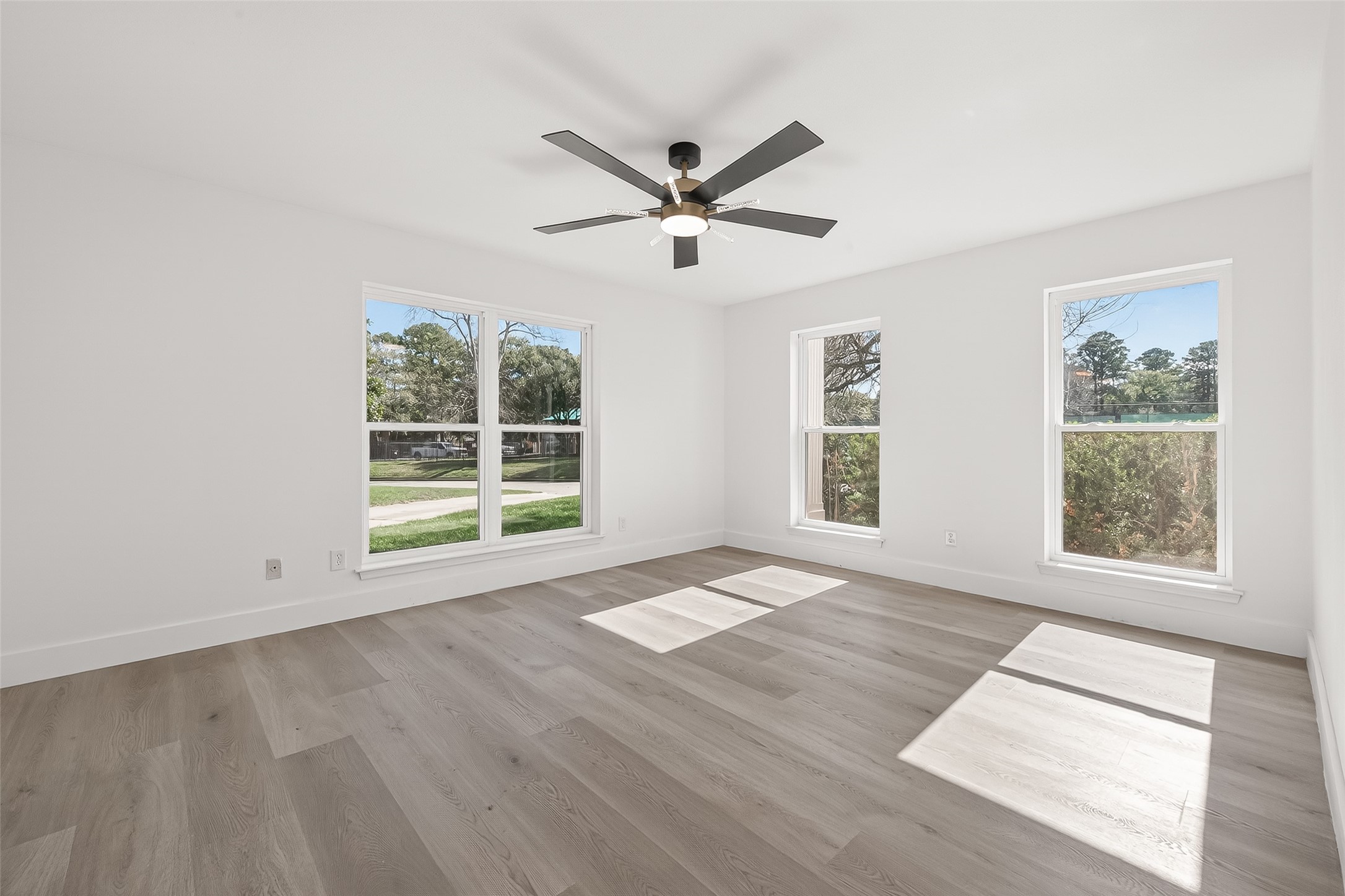 6210 Rippling Hollow Drive Spring, TX 77379 - Photo 23 of 50 a view of an empty room with a window and wooden floor
