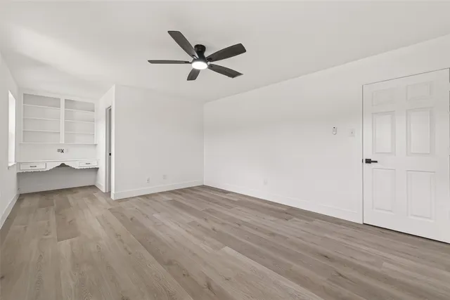 a view of a livingroom with wooden floor and window