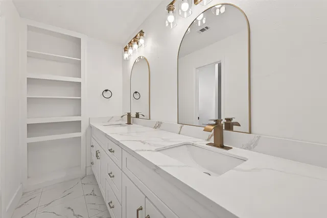 a bathroom with a double vanity sink and a mirror