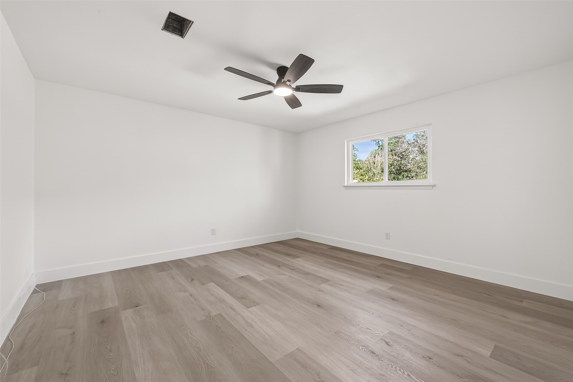 6210 Rippling Hollow Drive Spring, TX 77379 - Photo 42 of 50 an empty room with wooden floor and windows