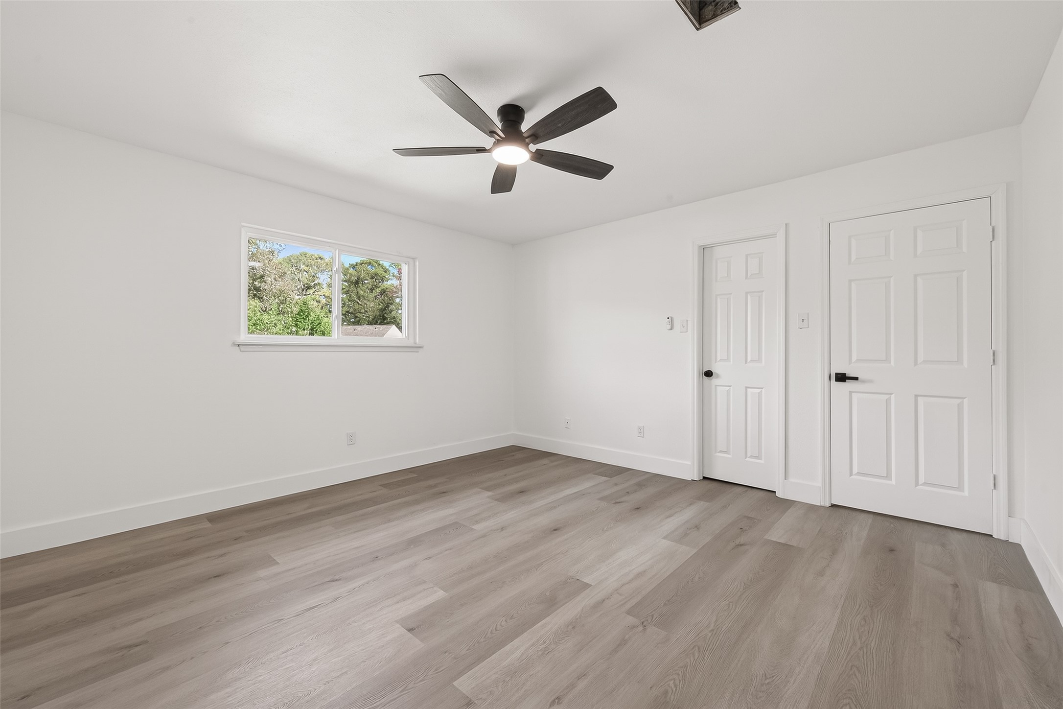 6210 Rippling Hollow Drive Spring, TX 77379 - Photo 43 of 50 an empty room with wooden floor and windows