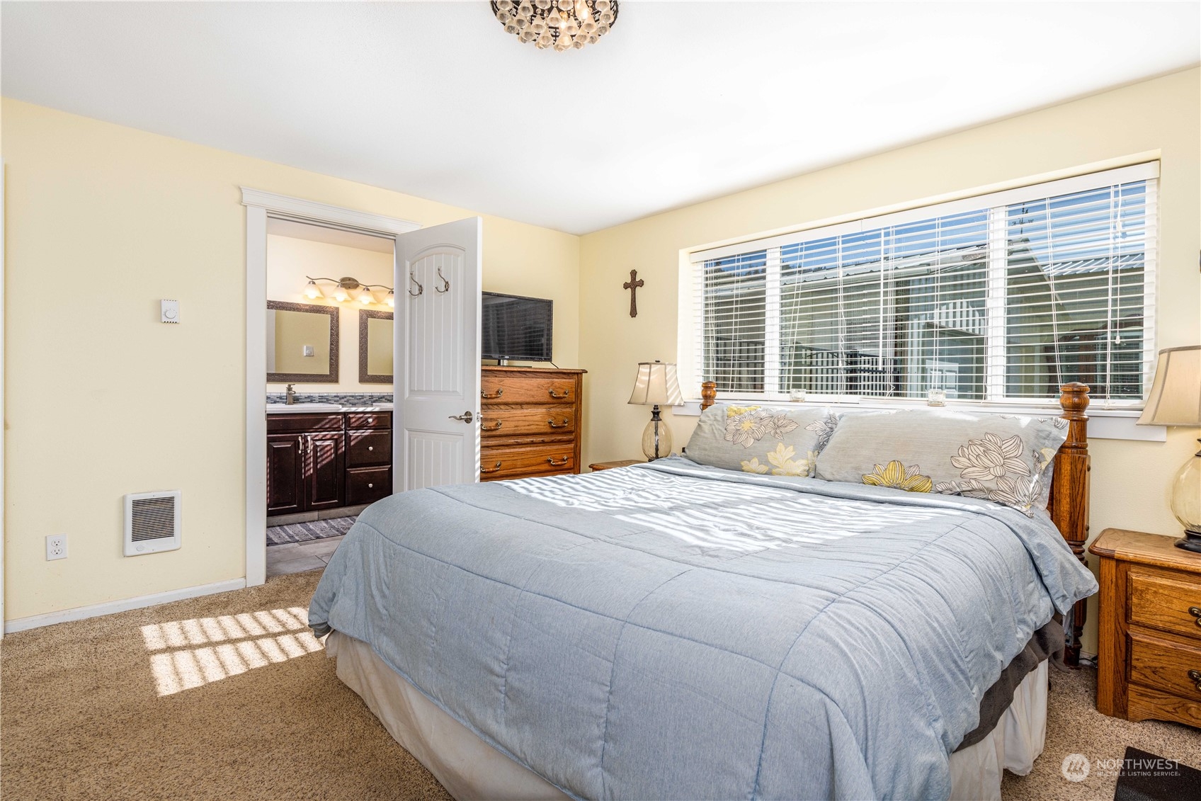 142 Literal Road Chehalis, WA 98532 - Photo 12 of 40 a bedroom with a bed wooden floor and flat screen tv