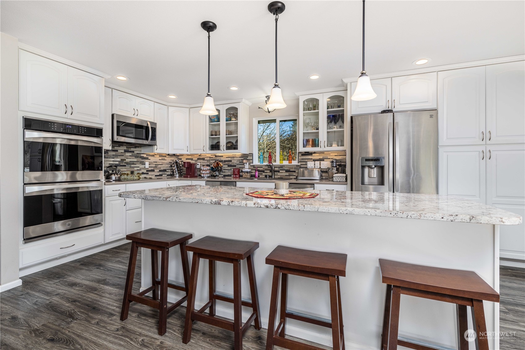 142 Literal Road Chehalis, WA 98532 - Photo 21 of 40 a kitchen with stainless steel appliances a dining table chairs sink and microwave