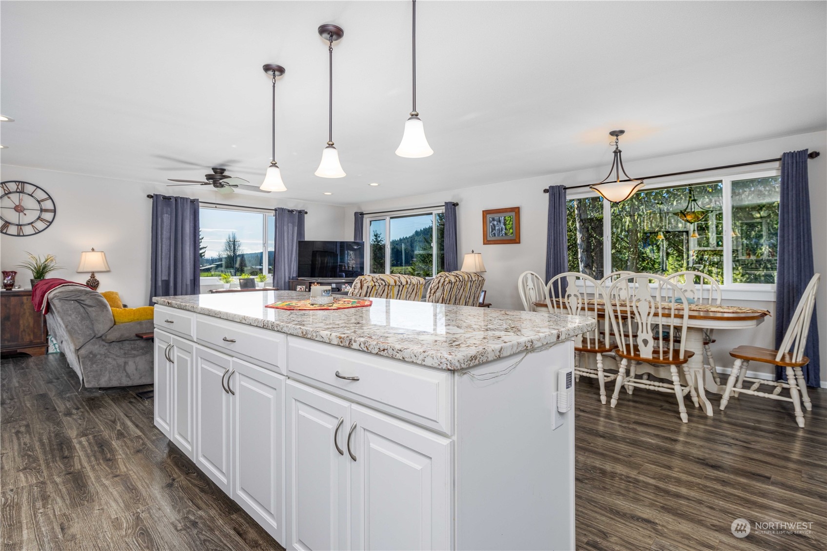 142 Literal Road Chehalis, WA 98532 - Photo 23 of 40 a kitchen with stainless steel appliances granite countertop a kitchen island a stove and a wooden floors