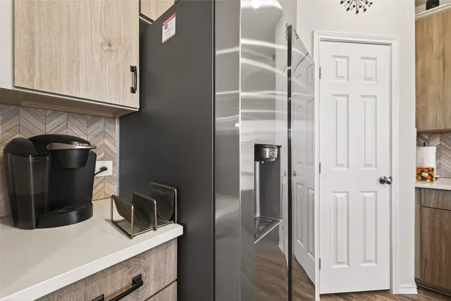 a view of a kitchen with refrigerator and cabinet