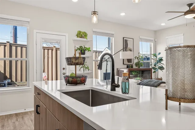 a kitchen with stainless steel appliances granite countertop a sink a stove and a refrigerator