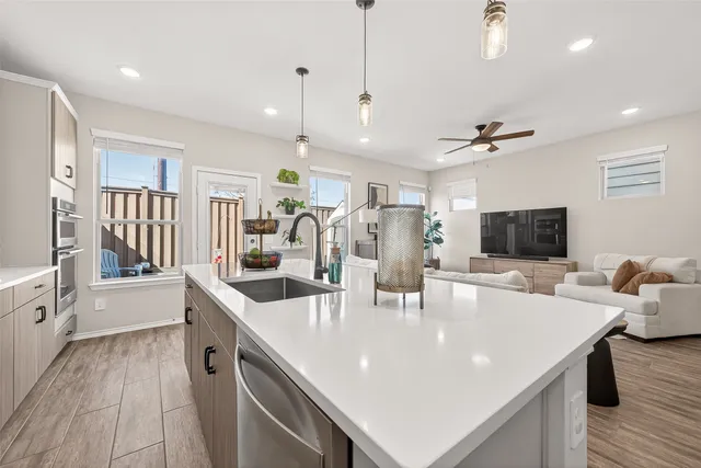a large kitchen with kitchen island a sink table and chairs