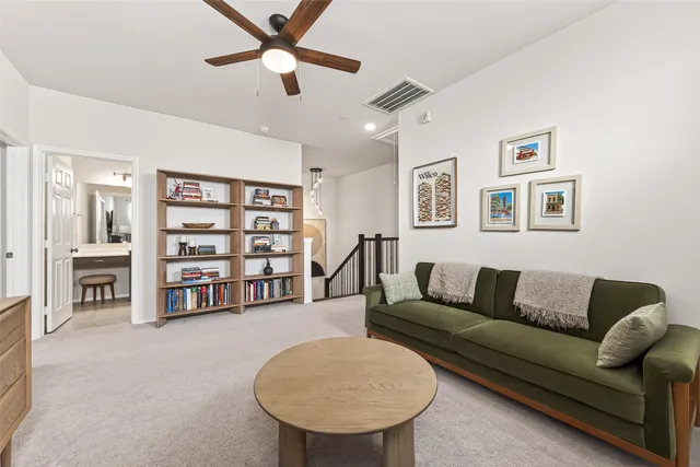 a living room with a couch and a bookshelf