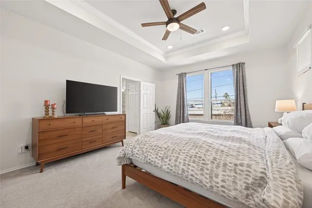 a bedroom with a large bed and a flat screen tv