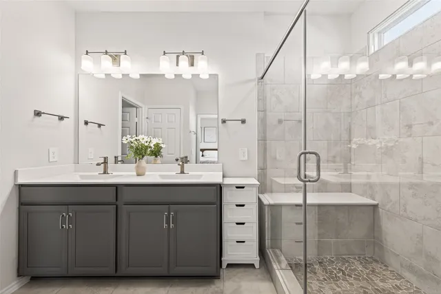 a bathroom with a sink vanity granite and a mirror
