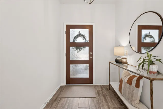 a view of an entryway with wooden floor
