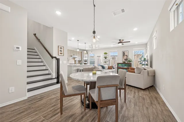 a living room with furniture a wooden floor and a chandelier