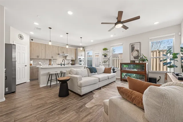 a living room with furniture kitchen view and a refrigerator