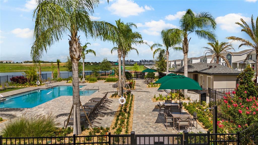 1660 Rider Rain Lane Apopka, FL 32703 - Photo 24 of 29 a view of a swimming pool with a table and chairs