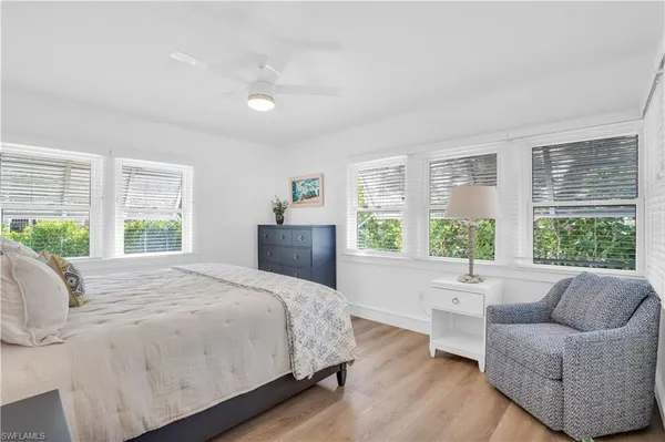 a spacious bedroom with a bed and a large window