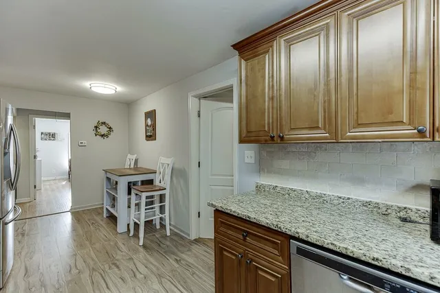an empty room with wooden floor and furniture