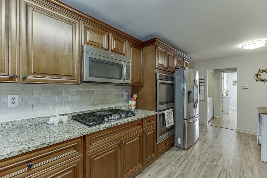 2838 North Bogan Road Northeast Buford, GA 30519 - Photo 17 of 39 a kitchen with stainless steel appliances granite countertop a refrigerator and stove