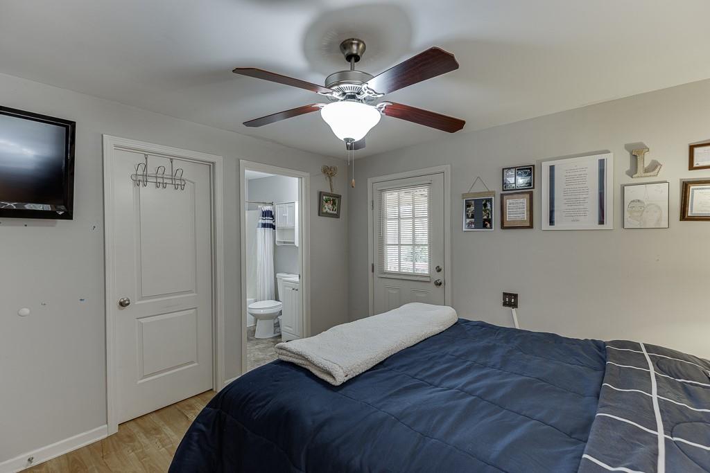 2838 North Bogan Road Northeast Buford, GA 30519 - Photo 19 of 39 a bedroom with a large bed and a flat tv screen