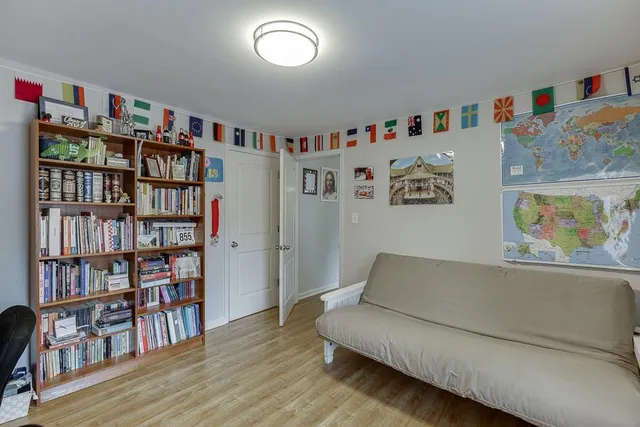 a living room with furniture and a book shelf
