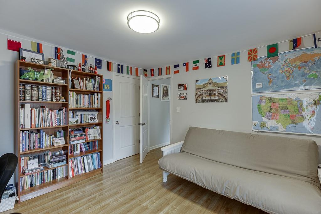 2838 North Bogan Road Northeast Buford, GA 30519 - Photo 23 of 39 a living room with furniture and a book shelf