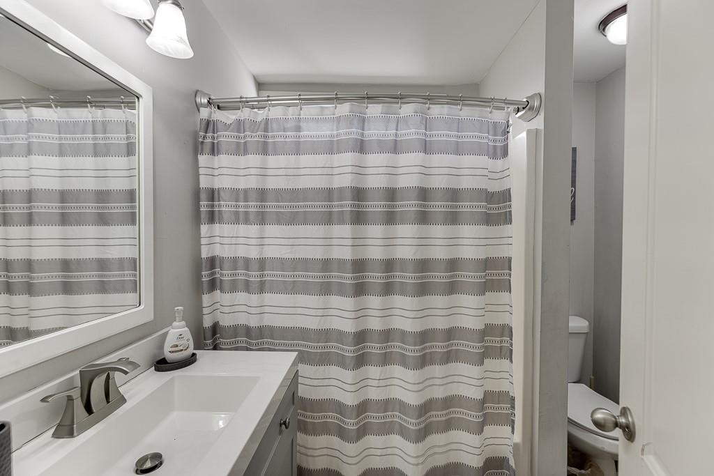 2838 North Bogan Road Northeast Buford, GA 30519 - Photo 24 of 39 a bathroom with a sink a toilet and shower